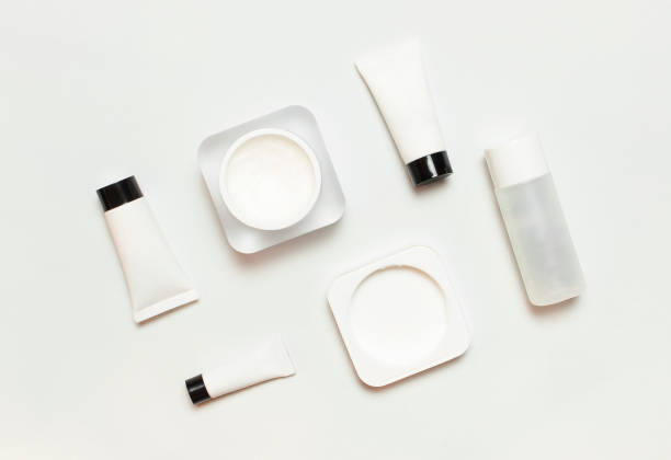 istock White cosmetic bottle containers on light background top view flat lay. Cosmetics SPA branding mock-up, Natural organic beauty product concept, Minimalism cosmetics style 1365380053
