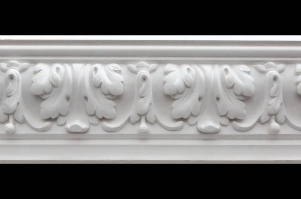 istock A fragment of a white plaster ceiling molding with an ornament. 1365380080