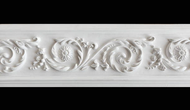 A fragment of a white plaster ceiling molding with an ornament.