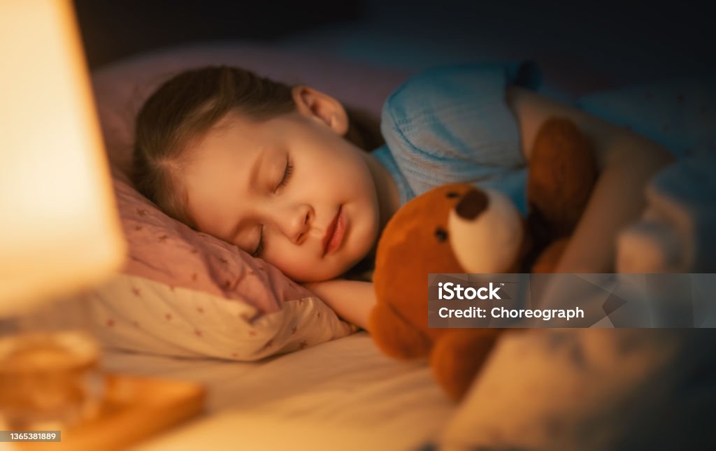 child is sleeping in the bed Adorable little child is sleeping in the bed. Child Stock Photo