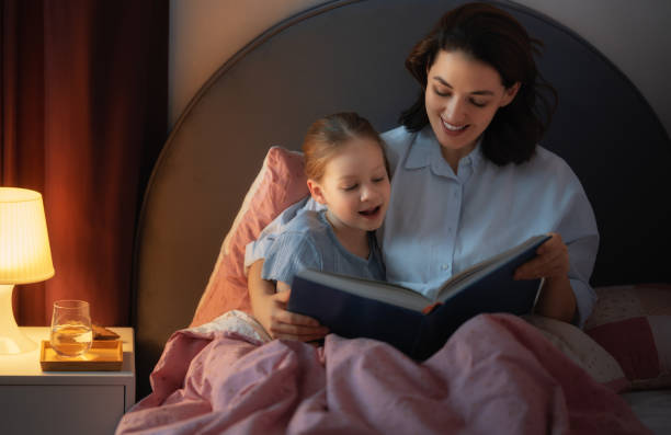 istock mother reading a book to her daughter 1365381926