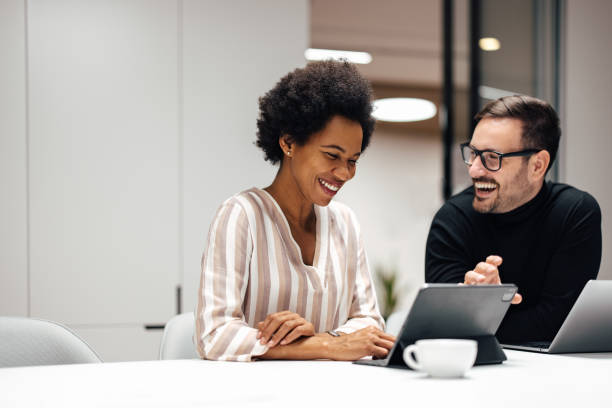istock Two business people, working together at the office 1365384246