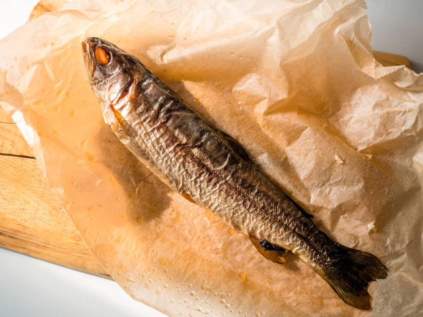 smoked fish on paper, top view. cold smoked trout fish with spices, tasty fish appetizer - smoked salmon salt healthy lifestyle cold imagens e fotografias de stock