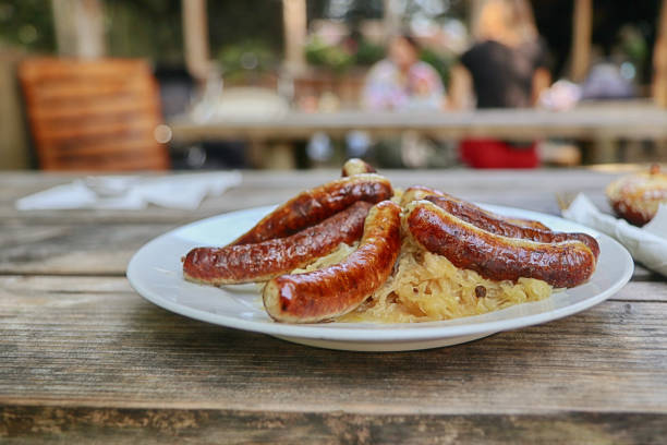 Beer garden German food: grilled bratwurst and sauerkraut (Nuremberg sausages and cabbages) Beer garden German food: grilled bratwurst and sauerkraut (Nuremberg sausages and cabbages) franconia stock pictures, royalty-free photos & images