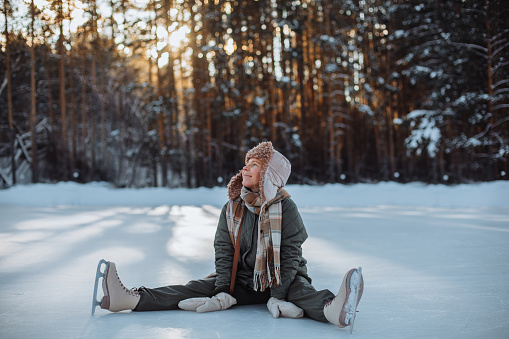 Portrait of happy beautiful girl, young joyful positive woman walking playing with snow, snowflakes, having fun outdoors in winter clothes, hat and scarf, smiling. Winter season, weather . High quality photo