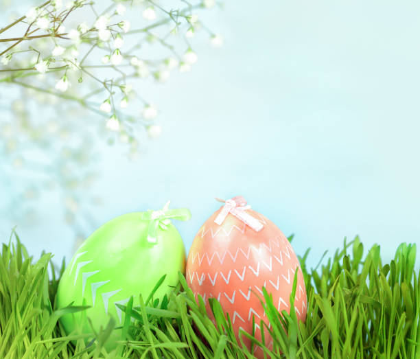 istock Easter eggs in the green grass under a flowering tree 1365389971