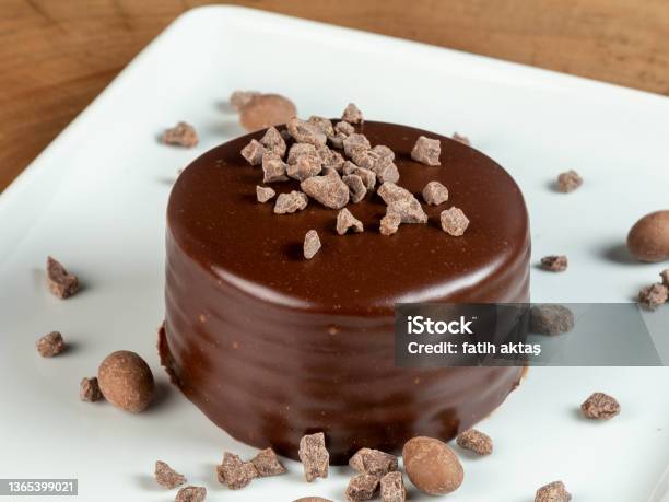Chocolate Chip Cake On White Plate On Wood Stock Photo - Download Image Now - Cake, Mocha, Candied Fruit