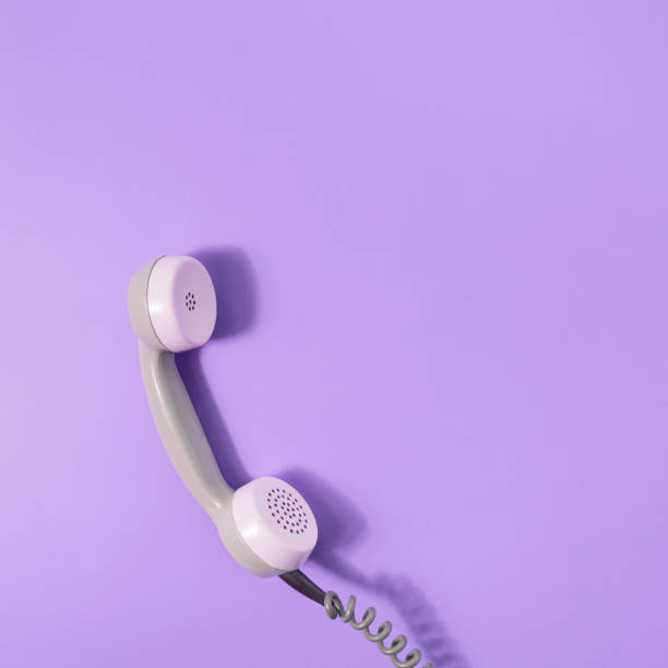 istock Retro style visual with phone receiver on pastel purple background. Minimal flat lay. Communication scene with copy space. 1365400276