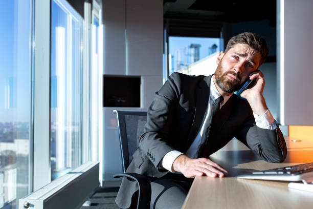 istock bored businessman works in the office, at the computer, falls asleep and tired of routine work 1365400320
