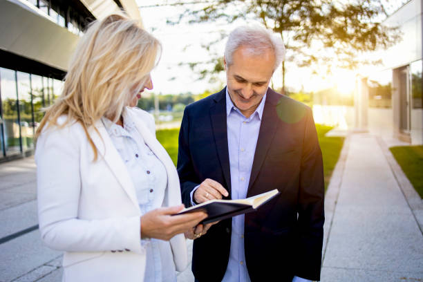 istock Two senior businessmen considering a business plan 1365400805