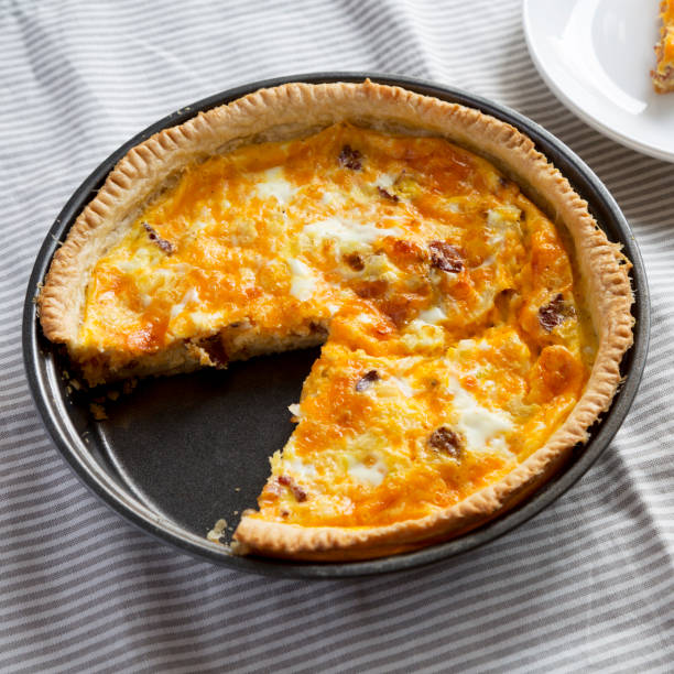istock Homemade Bacon Quiche with Eggs and Cheddar Cheese, low angle view. 1365402296