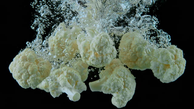 SLO MO LD Cauliflower florets falling into water
