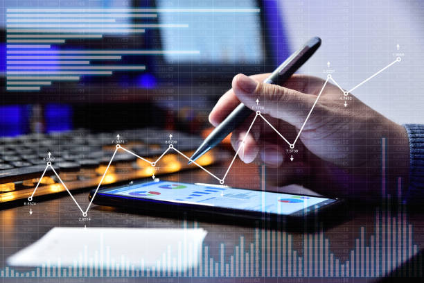 istock Businessman with smart phone working in night office 1365404498