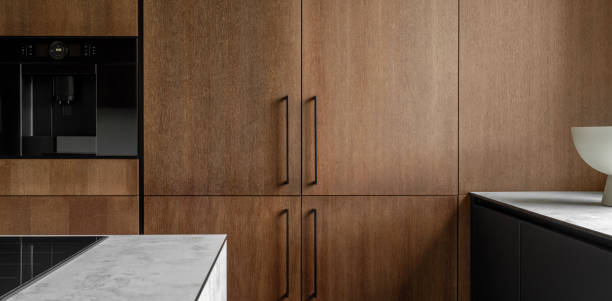 istock Modern minimalistic kitchen with black and wooden surfaces, marble kitchen island top and household appliances. Modern Concept For Interior Design And Architecture. 1365404741