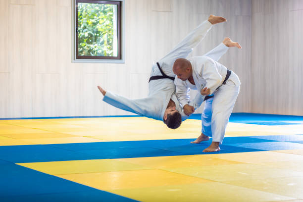 istock Two adult man practicing judo in the sports hall. 1365404830