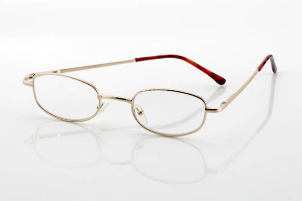 istock Reading glasses on white background with shadow and differential focus 1365404928
