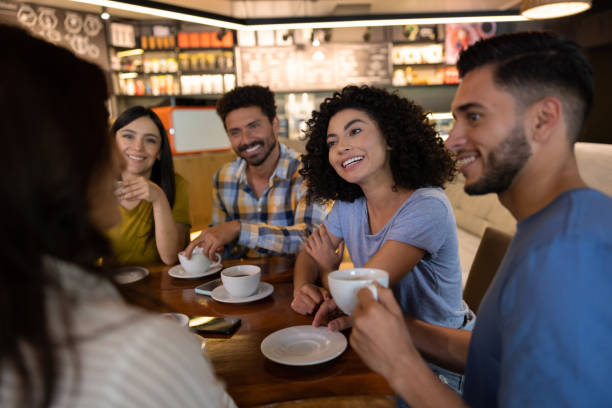 istock Happy friends having a cup of coffee at a restaurant while sharing stories 1365405023