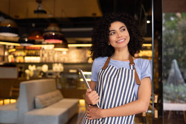 istock Happy woman working as a waitress at a restaurant 1365405040