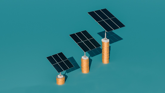 Three solar panels in different sizes stands on top of stacks of golden coins. Concept of sustainable investment.