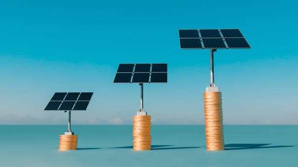 istock Solar panels stand on three stacks of golden coins 1365407588