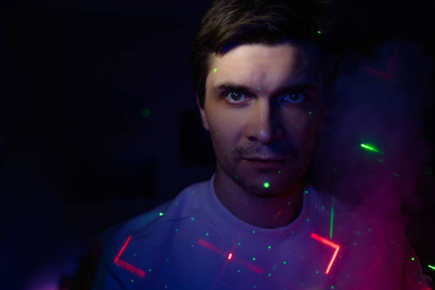 istock Creative idea, concept. young man and a projection of colored patterns on smoke. 1365407614