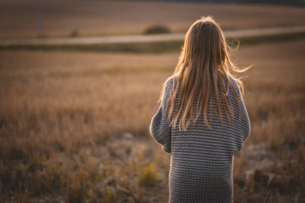 istock A child walks around the field wrapped in a blanket. 1365409171