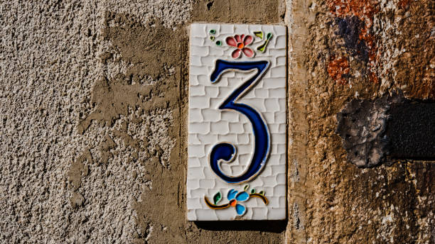 istock house number 3 in ceramic on gray wall. house number 1365409529
