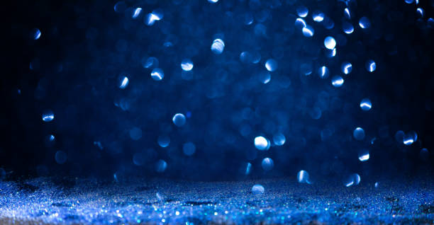 istock background of abstract  blue  glitter lights 1365409724