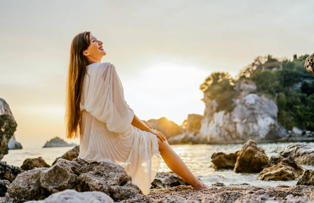 istock Smiling woman enjoying the beach 1365410337