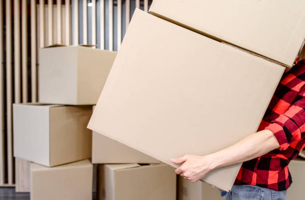 istock Close up hands of a man holding a cardboard box 1365410447