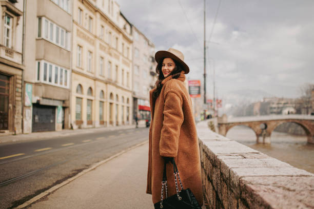istock A smiling young woman at the downtown district 1365410449