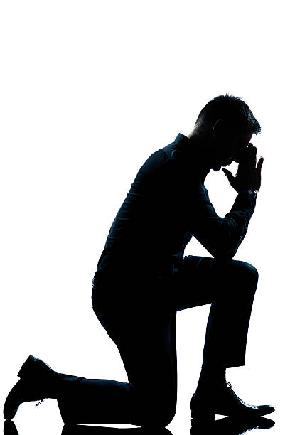 istock silhouette man kneeling full length 136541194