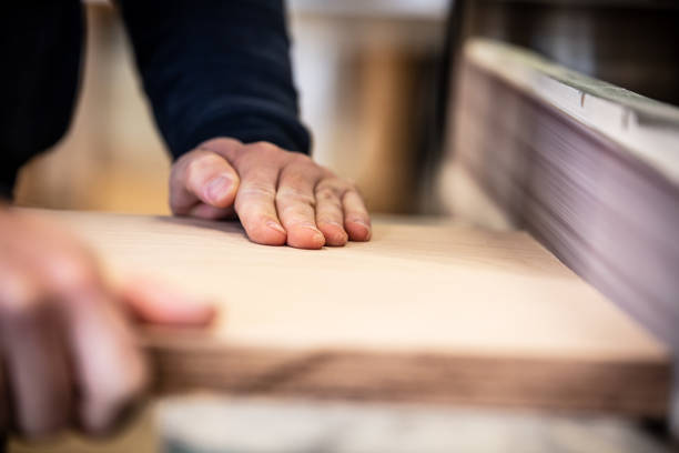 istock male craftman is working with a belt grinder 1365412371