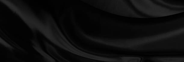 istock Black gray satin dark fabric texture luxurious shiny that is abstract silk cloth background with patterns soft waves blur beautiful. 1365412374