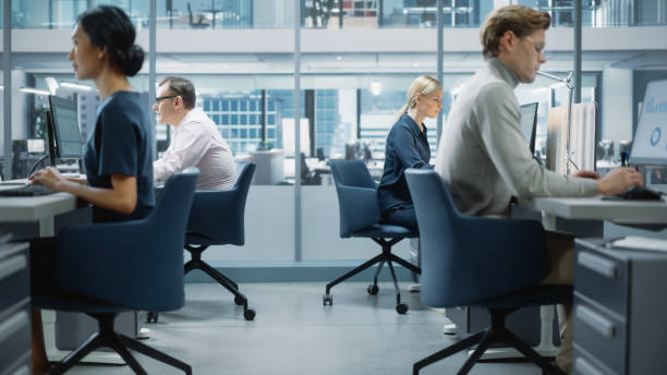 istock Diverse Team of Finance Managers Working with Statistical Data in Modern Big City Office. Colleagues Work on New Business Opportunities, Evaluate Financial Reports, Plan Investment Strategy. 1365412427