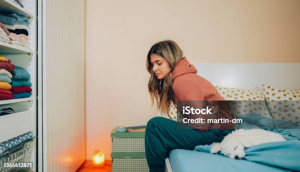 Woman With Stomach Pain Staying Home Stock Photo - Download Image Now - Menstruation, Endometriosis, Pain