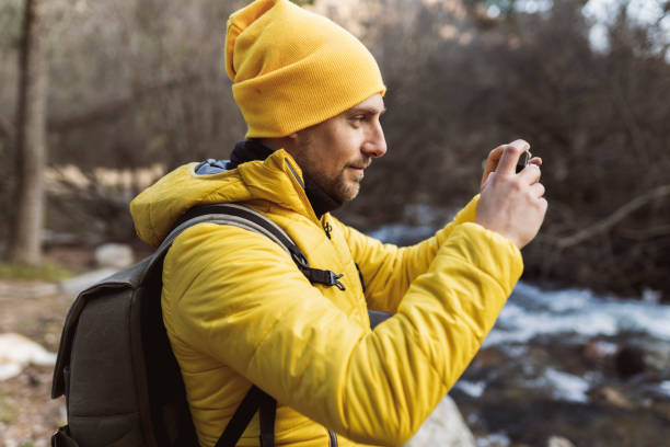 istock Backpacker traveler on trekking taking photos with camera 1365413347