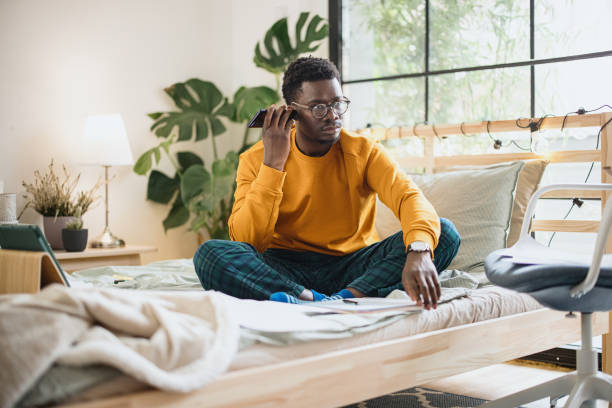 istock Young man talking on speakerphone, dictating voice message, using online translator app or voice recognition software, virtual assistant 1365414988