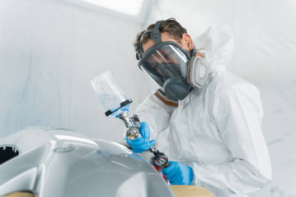 istock Male car painter during painting vehicle body elements 1365415833