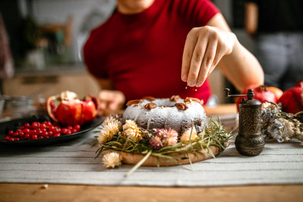 istock Woman decorating cake with different chopped nuts 1365416219