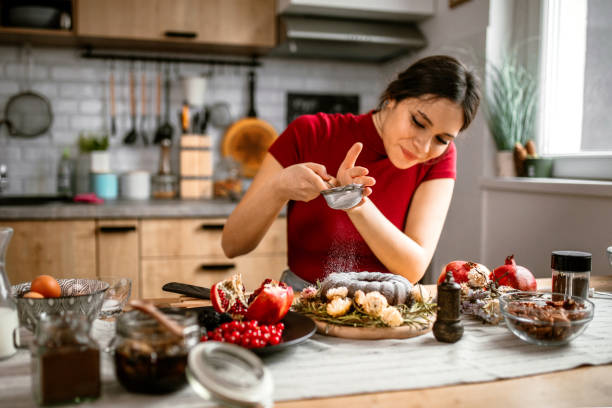 istock Woman decorating cake with powdered sugar and nuts 1365416221
