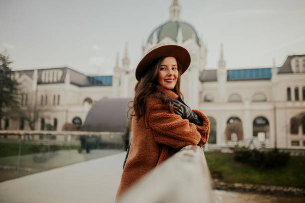 istock A smiling young woman at the downtown district 1365417338
