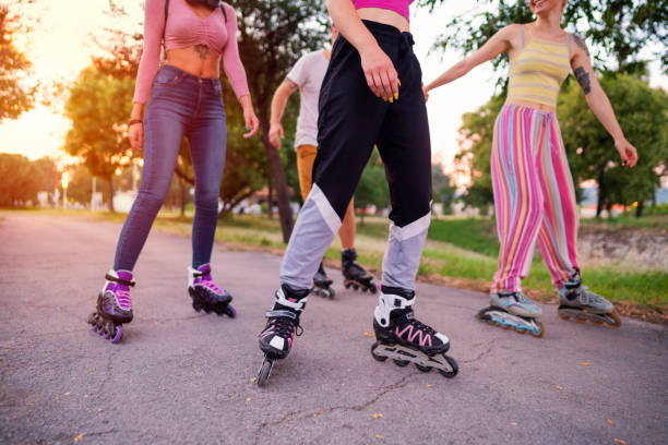 istock Low-angle view of a small group of unrecognizable  people rollerblading 1365418019