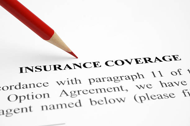 Red pencil over white document titled insurance coverage stock photo