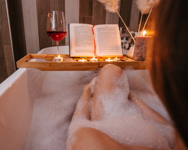 istock Woman reading in a bath 1365419308