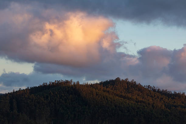 Sunset landscape formed by the hills, the clouds and the last lights, in front of the Garita da Vela, from Espasante, council of Ortigueira, Galicia, Spain
