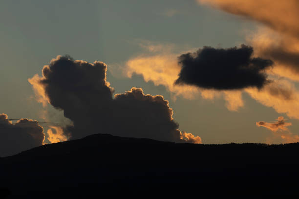 Sunset landscape formed by the hills, the clouds and the last lights, in front of the Garita da Vela, from Espasante, council of Ortigueira, Galicia, Spain