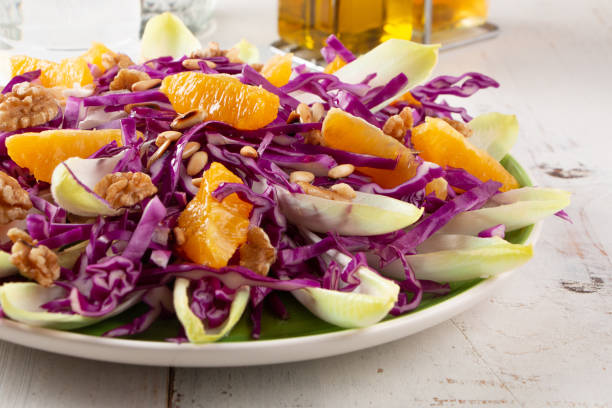 istock Delicious red cabbage salad with endive and orange fruit 1365421284