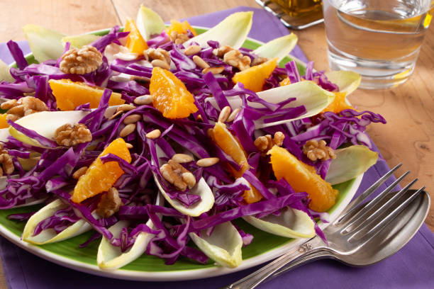 istock Red cabbage salad with endive, orange fruit, toasted pine nuts and walnuts 1365421288