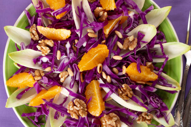 istock Red cabbage salad with endive, orange fruit and toasted pine nuts 1365421297